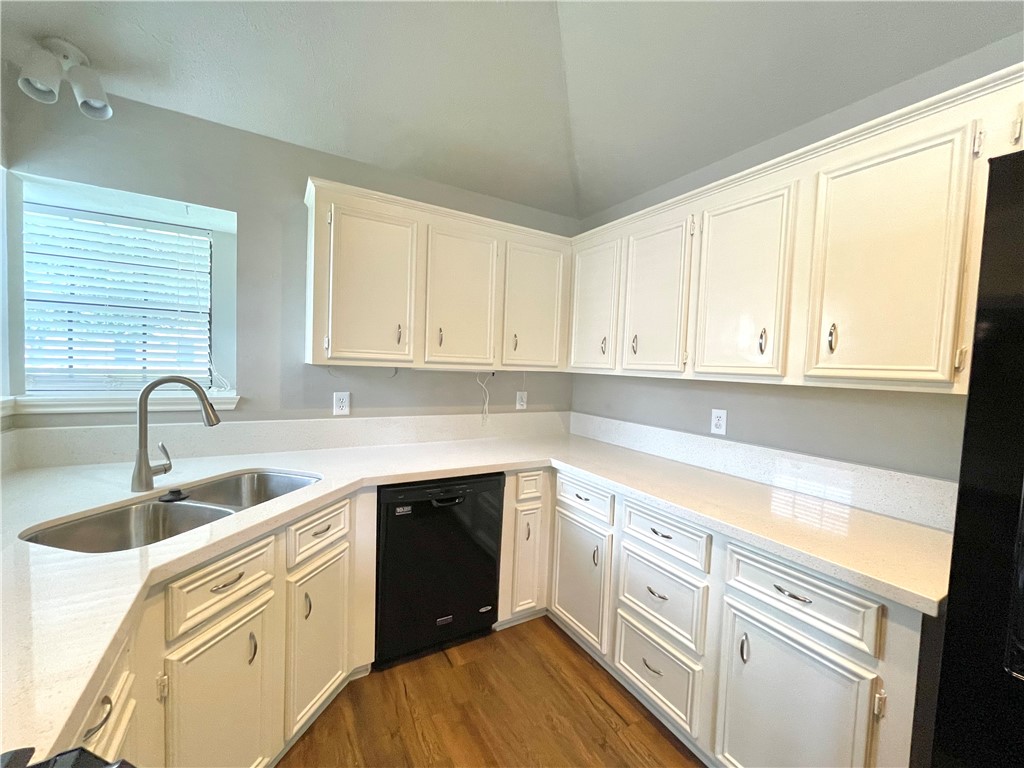 4508 Kensington Road Bryan, TX 77802 - Photo 8 of 25 Kitchen with dark hardwood / wood-style flooring, sink, white cabinets, and black dishwasher