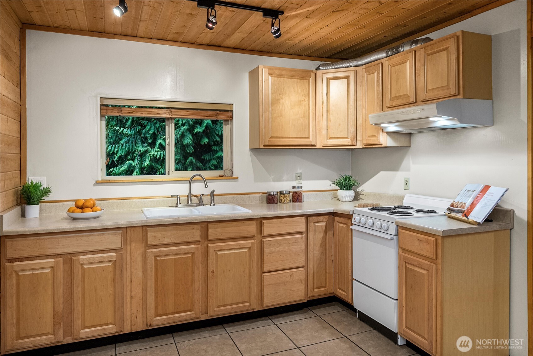 4692 Northeast Lincoln Road Poulsbo, WA 98370 - Photo 11 of 22 a kitchen with a sink window and cabinets