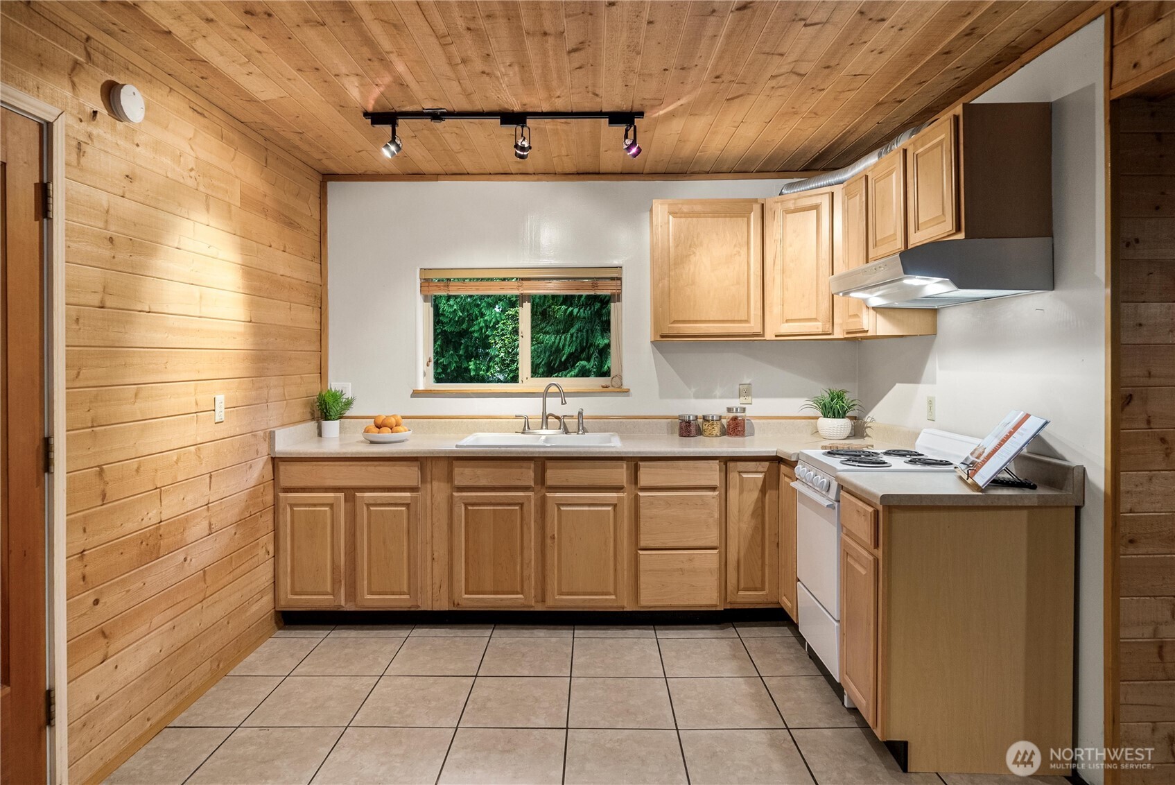 4692 Northeast Lincoln Road Poulsbo, WA 98370 - Photo 10 of 22 a kitchen with a sink window and cabinets