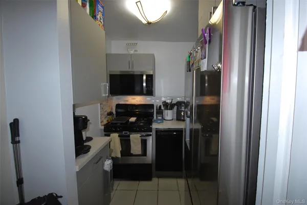a kitchen with a refrigerator and a stove top oven