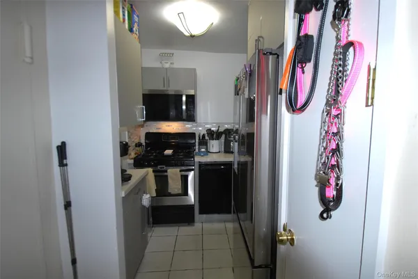 a kitchen with a refrigerator and a stove