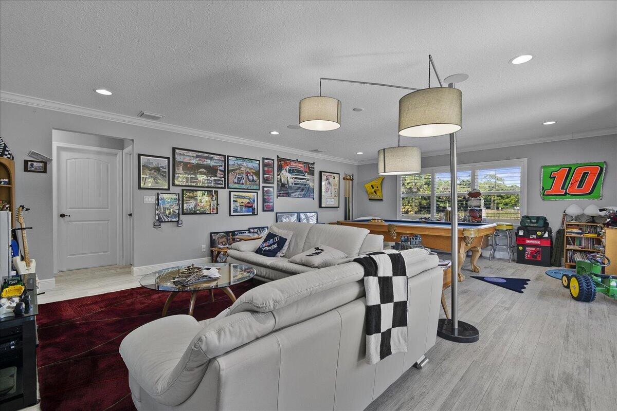 10975 Randolph Siding Road Jupiter, FL 33478 - Photo 62 of 97 a living room with furniture and a wooden floor