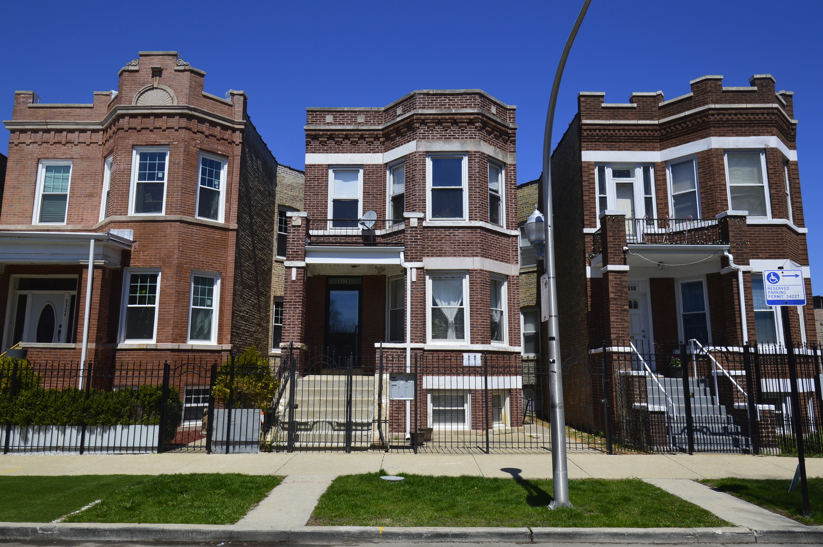 a front view of a residential apartment building with a yard