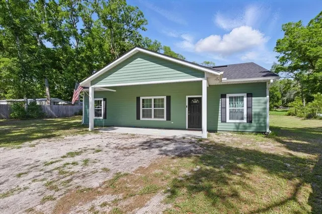 a front view of a house with a garden