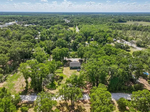 an aerial view of a house with a yard