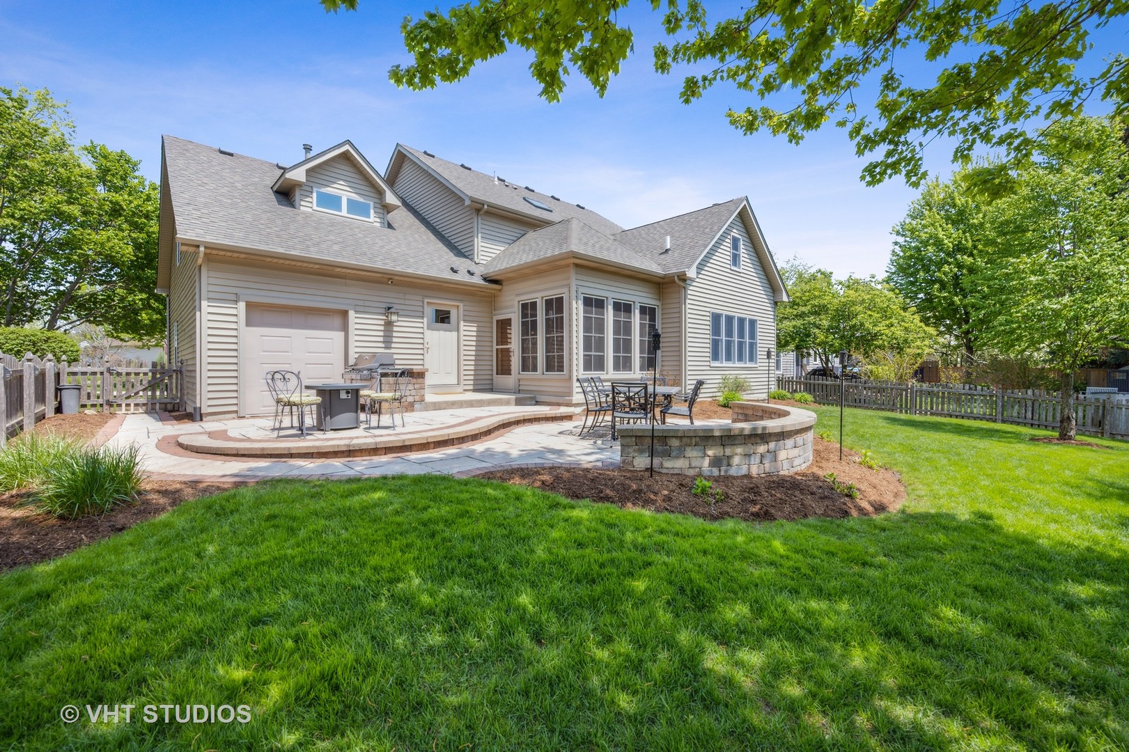 2758 Miller Road Geneva, IL 60134 - Photo 27 of 29 a patio with table and chairs with plants and wooden fence