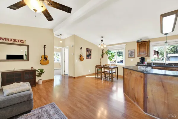 a view of a dining room with furniture wooden floor and a chandelier