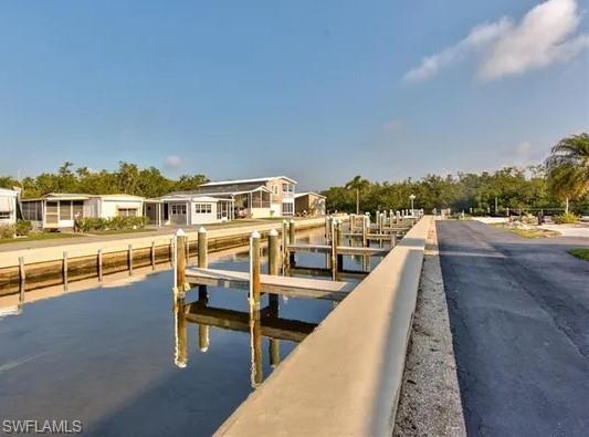 777 Walkerbilt Road, Unit 9 Naples, FL 34110 - Photo 14 of 17 a view of a swimming pool with a lounge chair