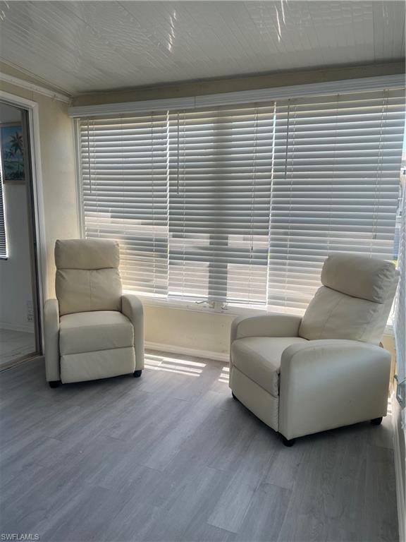 777 Walkerbilt Road, Unit 9 Naples, FL 34110 - Photo 5 of 17 a living room with furniture and a large window