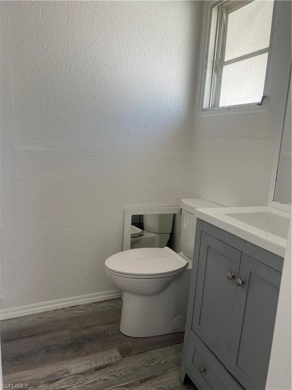 777 Walkerbilt Road, Unit 9 Naples, FL 34110 - Photo 10 of 17 a white toilet sitting next to a bathroom sink