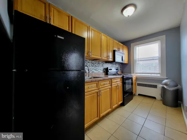 a kitchen with a sink a stove and a refrigerator