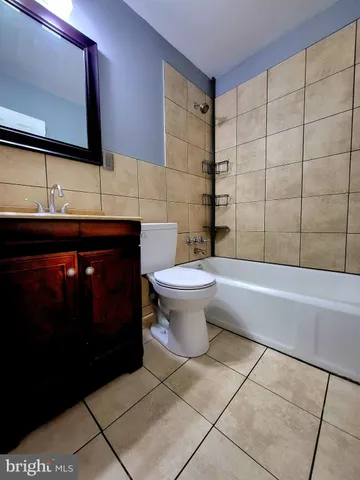 a bathroom with a sink a toilet and bathtub
