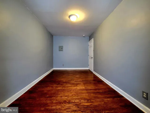 a view of room with wooden floor