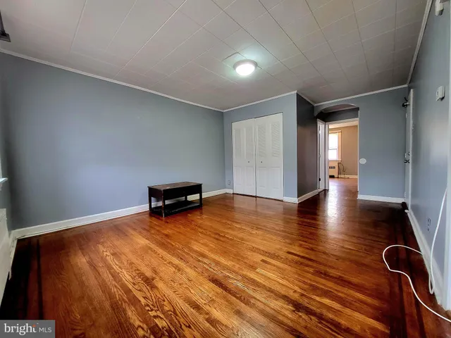 a view of a room with wooden floor and lounge chair