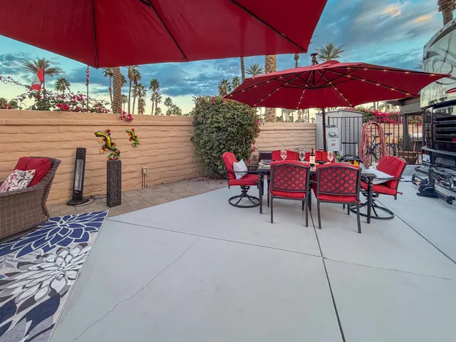 a patio with a patio table and chairs under an umbrella
