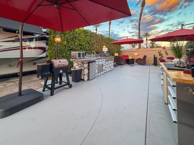 a view of a patio with table and chairs under an umbrella