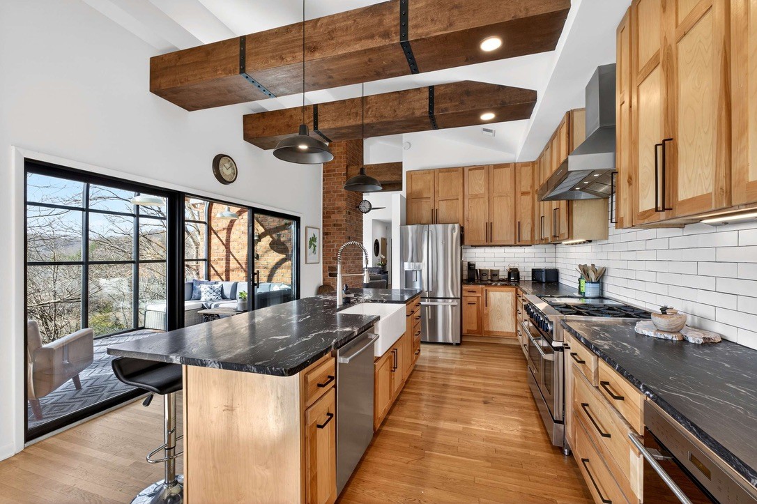 9467 Little East Fork Road Franklin, TN 37064 - Photo 12 of 26 a kitchen with stainless steel appliances granite countertop a sink a stove and a refrigerator