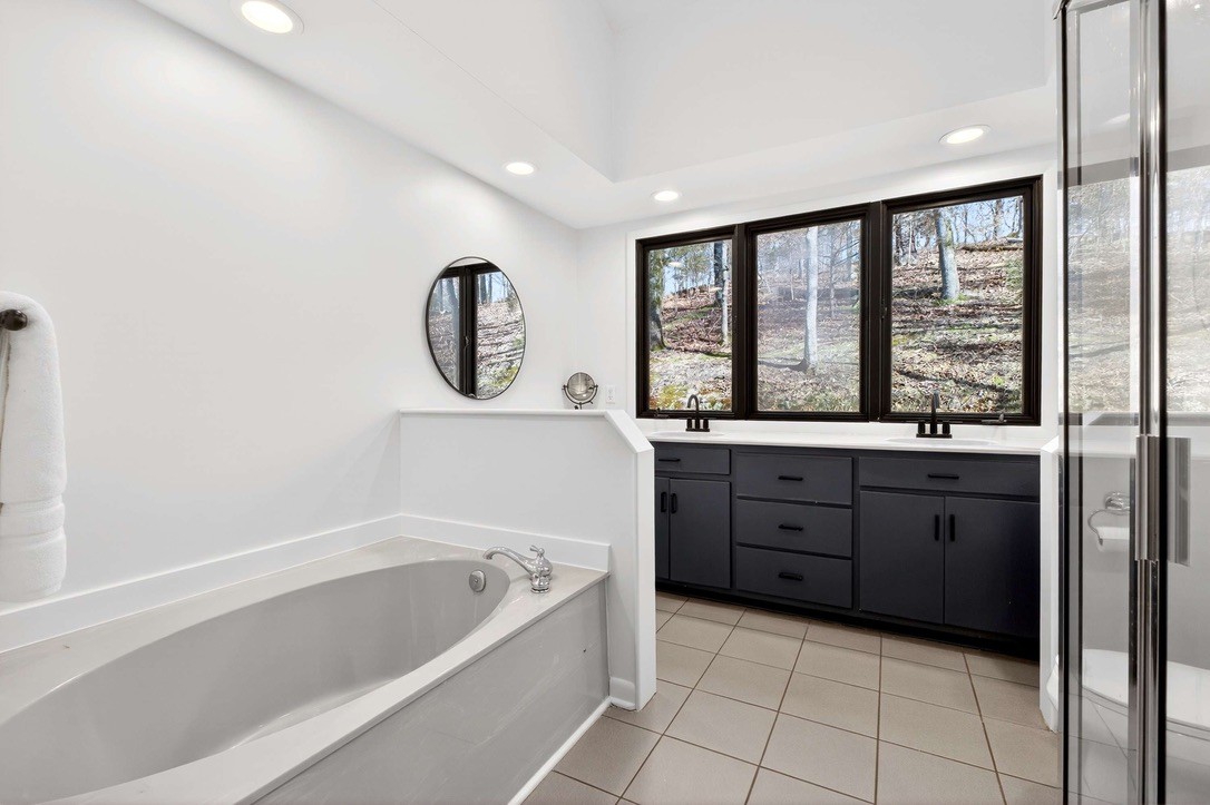 9467 Little East Fork Road Franklin, TN 37064 - Photo 16 of 26 a bathroom with a tub sink and mirror