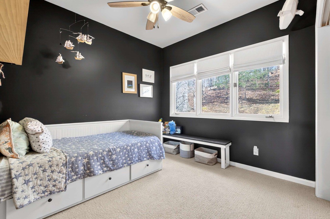 9467 Little East Fork Road Franklin, TN 37064 - Photo 17 of 26 a bedroom with a bed chandelier and a window