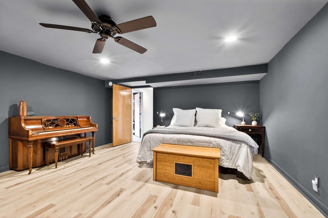 9467 Little East Fork Road Franklin, TN 37064 - Photo 21 of 26 a bedroom with a bed and a chandelier