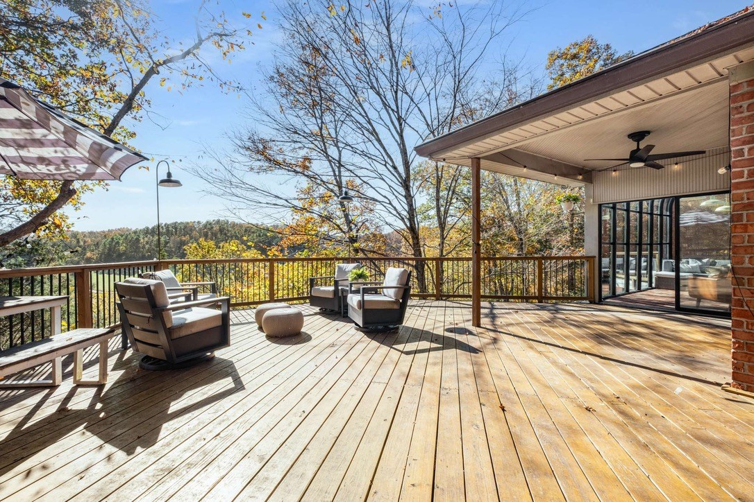 9467 Little East Fork Road Franklin, TN 37064 - Photo 4 of 26 a view of a balcony with wooden floor and outdoor seating