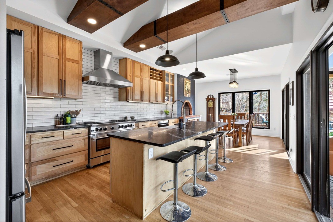 9467 Little East Fork Road Franklin, TN 37064 - Photo 9 of 26 a kitchen with stainless steel appliances granite countertop lots of counter top space and wooden floor