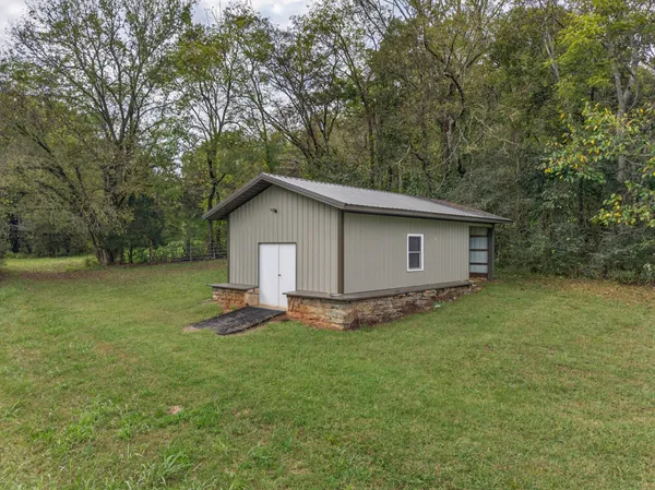 a view of a house with a yard and sitting area