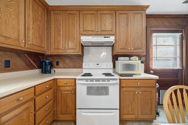 a kitchen with a stove top oven sink and cabinets