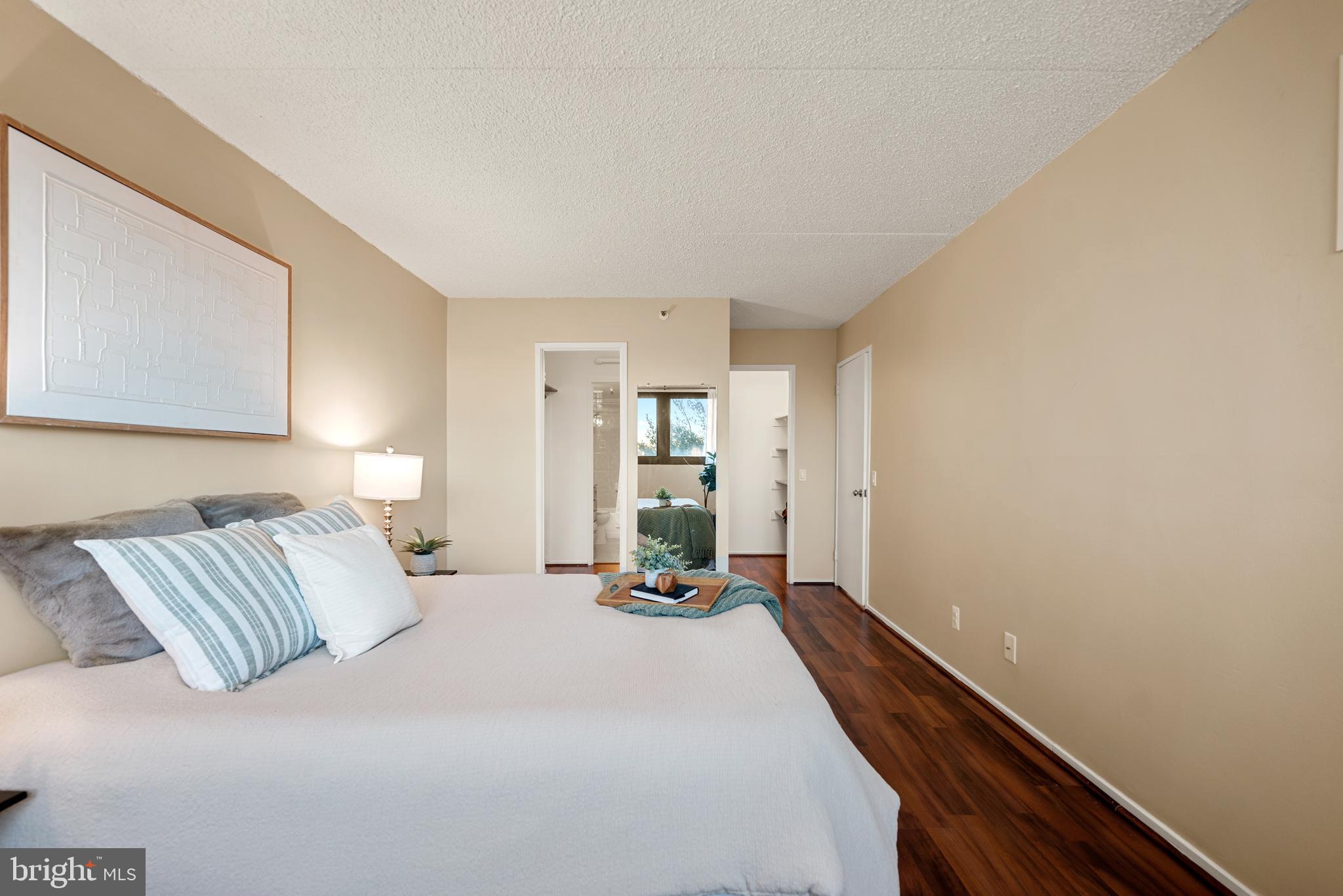 5911 Edsall Road, Unit 805 Alexandria, VA 22304 - Photo 15 of 37 a bedroom with a bed and wooden floor