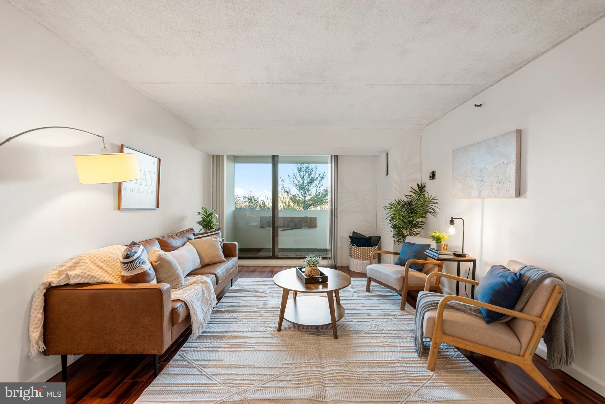 5911 Edsall Road, Unit 805 Alexandria, VA 22304 - Photo 2 of 37 a living room with furniture and a lamp