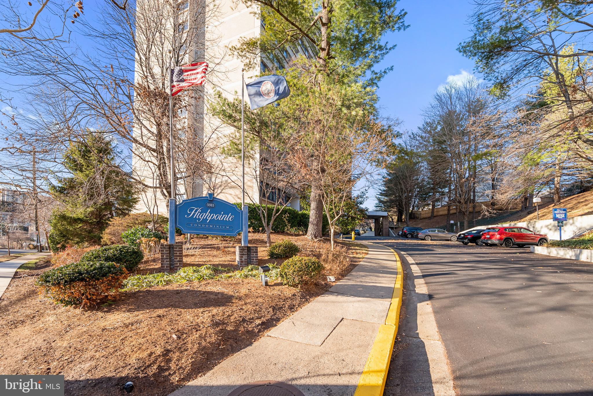 5911 Edsall Road, Unit 805 Alexandria, VA 22304 - Photo 33 of 37 a view of a park with pathway and a cars parked on the side of road