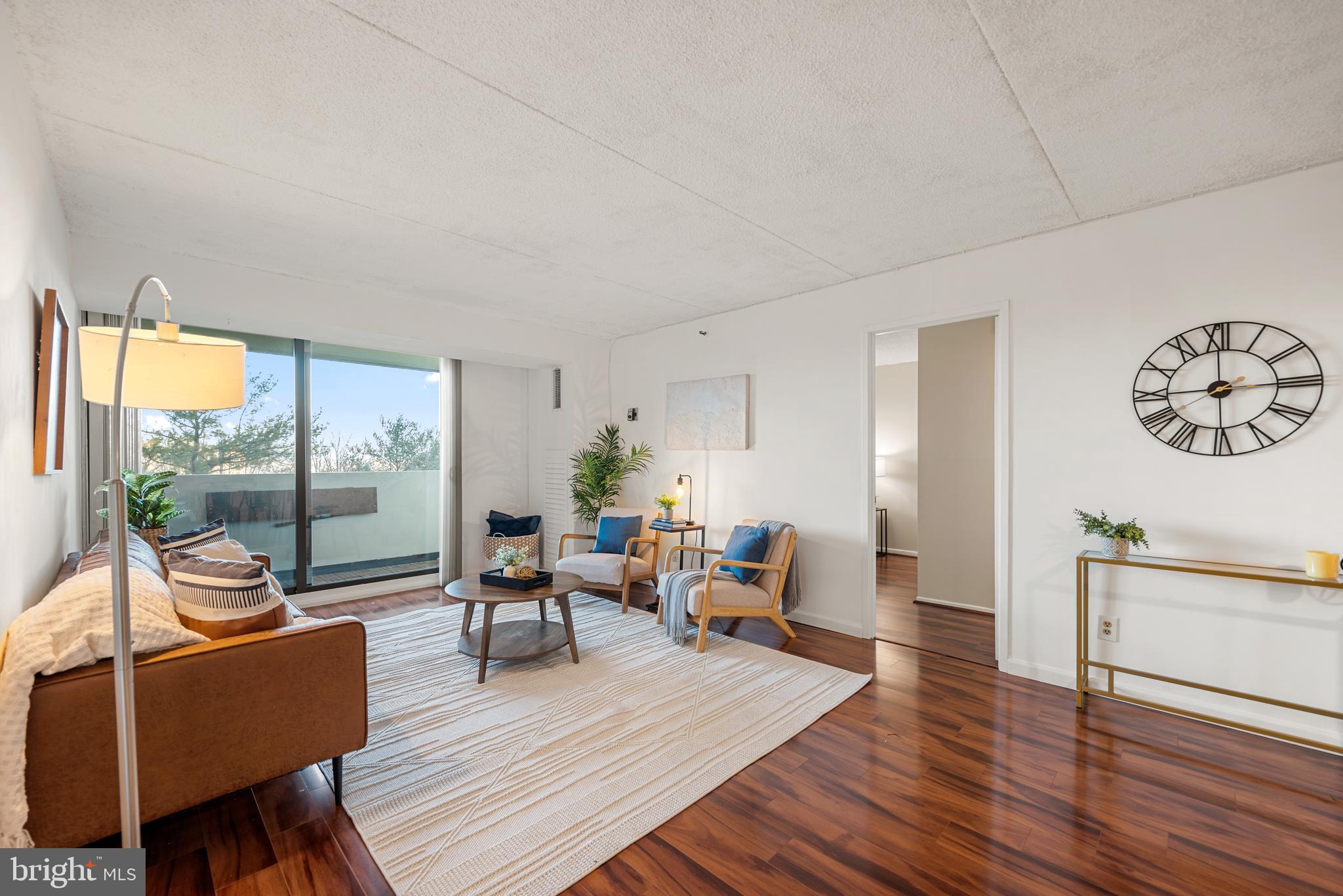 5911 Edsall Road, Unit 805 Alexandria, VA 22304 - Photo 4 of 37 a living room with furniture a large window and wooden floor