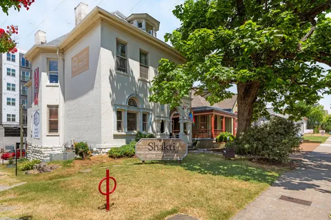 a view of a house with backyard porch and sitting area