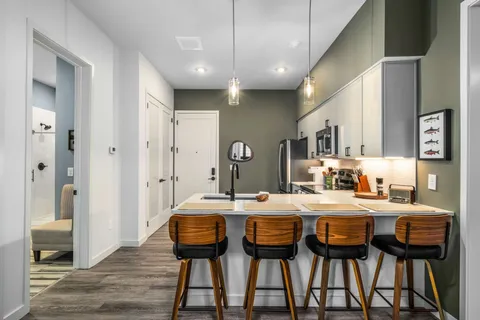 a dining room with a table chairs and entryway