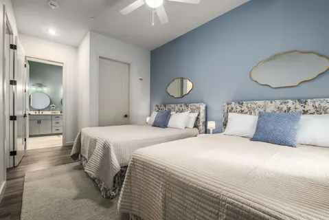 a bedroom with bed and a chandelier