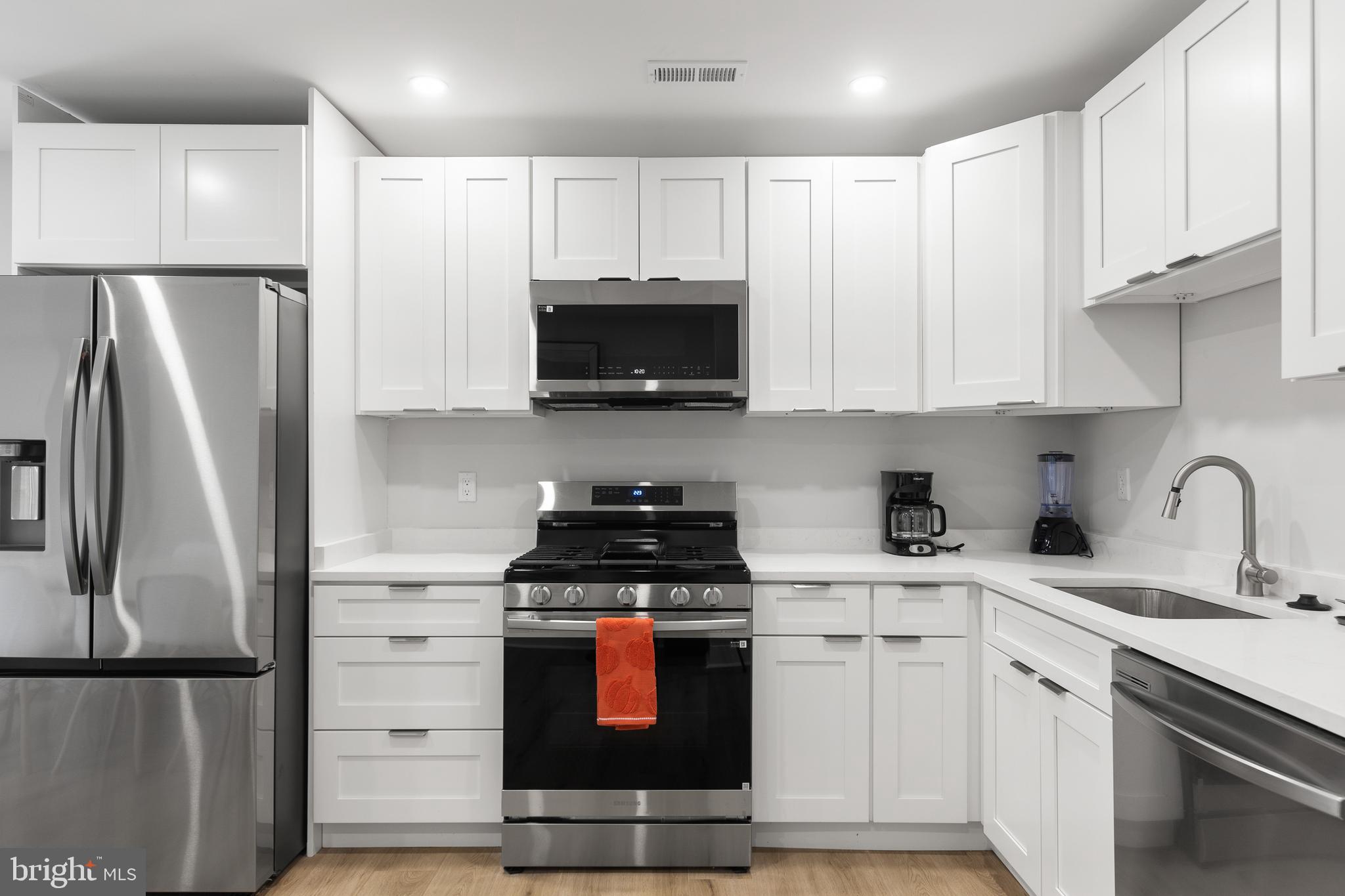 2918 17th Street South Arlington, VA 22204 - Photo 11 of 30 a kitchen with stainless steel appliances granite countertop a refrigerator sink and white cabinets