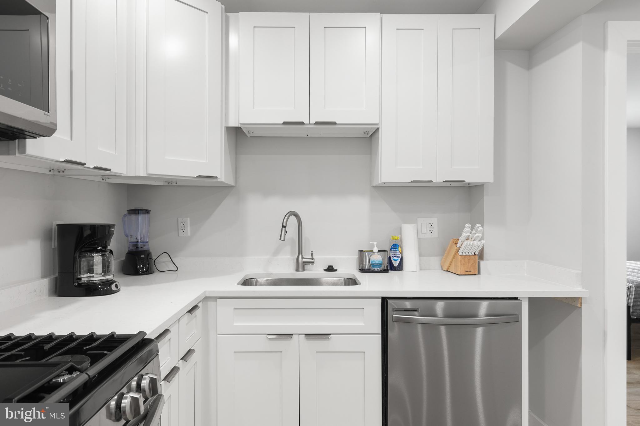 2918 17th Street South Arlington, VA 22204 - Photo 12 of 30 a kitchen with stainless steel appliances granite countertop a sink stove and cabinets