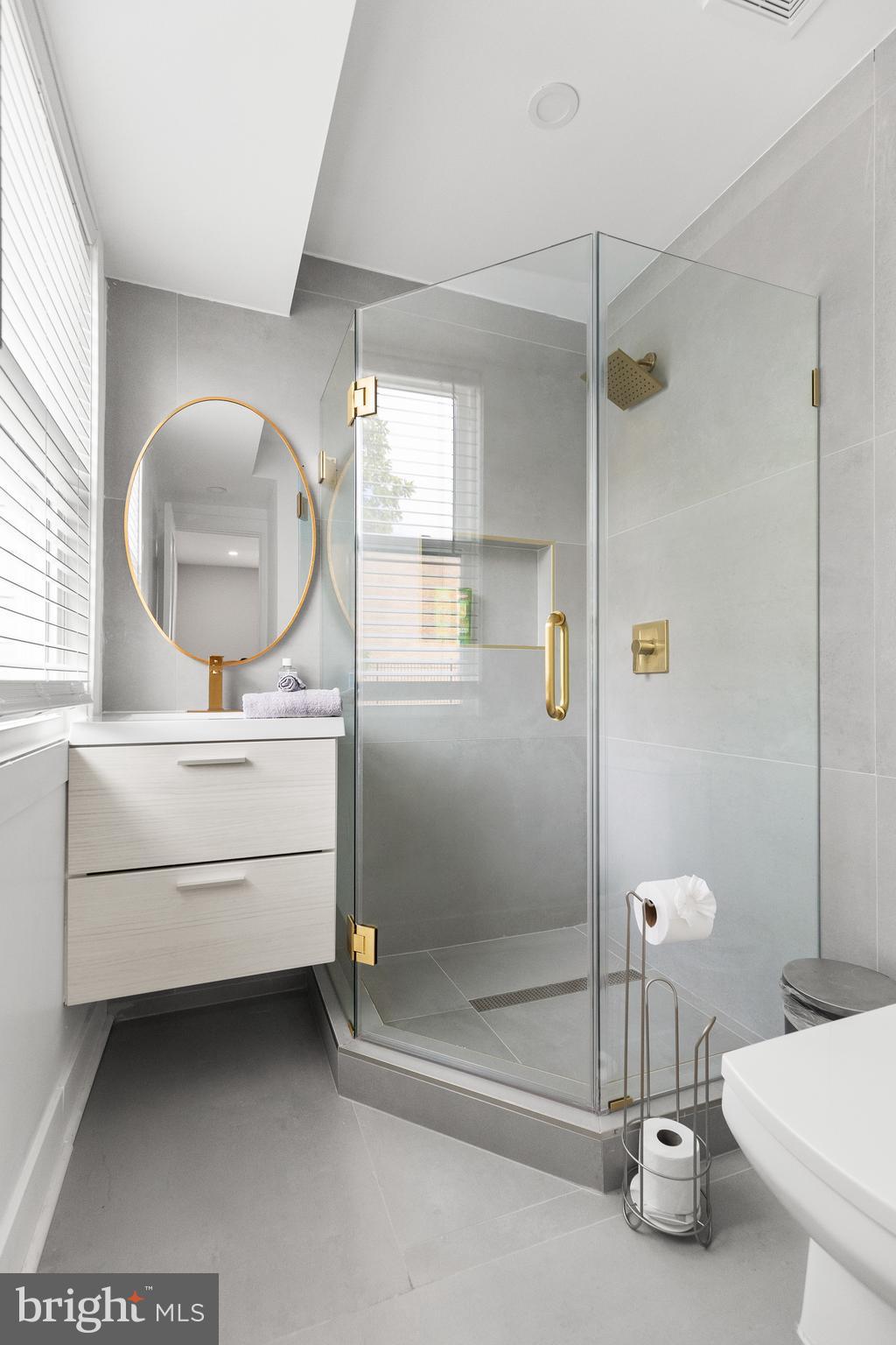 2918 17th Street South Arlington, VA 22204 - Photo 15 of 30 a bathroom with a sink a toilet and a mirror