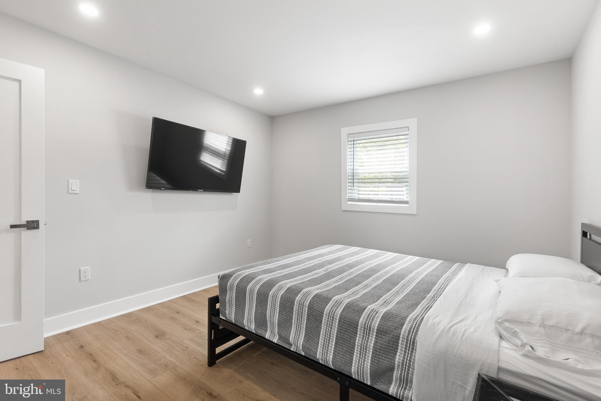 2918 17th Street South Arlington, VA 22204 - Photo 17 of 30 a bedroom with a bed and a flat screen tv