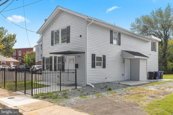 a view of a house with a yard and fence