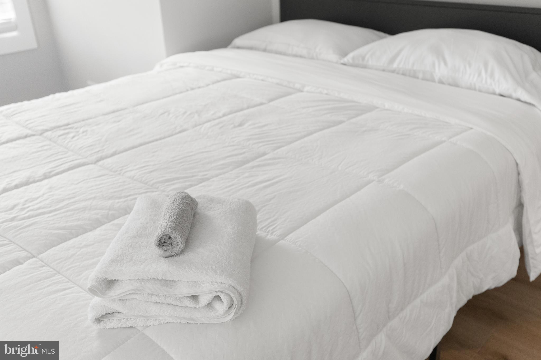 2918 17th Street South Arlington, VA 22204 - Photo 21 of 30 a large white bed in a small room