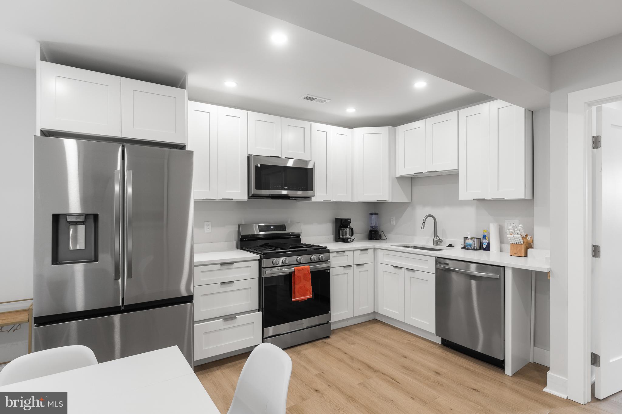 2918 17th Street South Arlington, VA 22204 - Photo 10 of 30 a kitchen with stainless steel appliances a refrigerator stove microwave and cabinets
