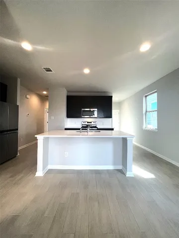 a bathroom with a granite countertop shower and a toilet