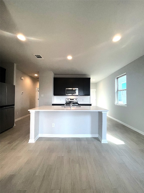 121 Old Stagecoach Road Jarrell, TX 76537 - Photo 11 of 23 a view of kitchen with kitchen island stainless steel appliances a sink counter space and a window