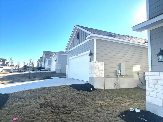 a view of a house with a backyard
