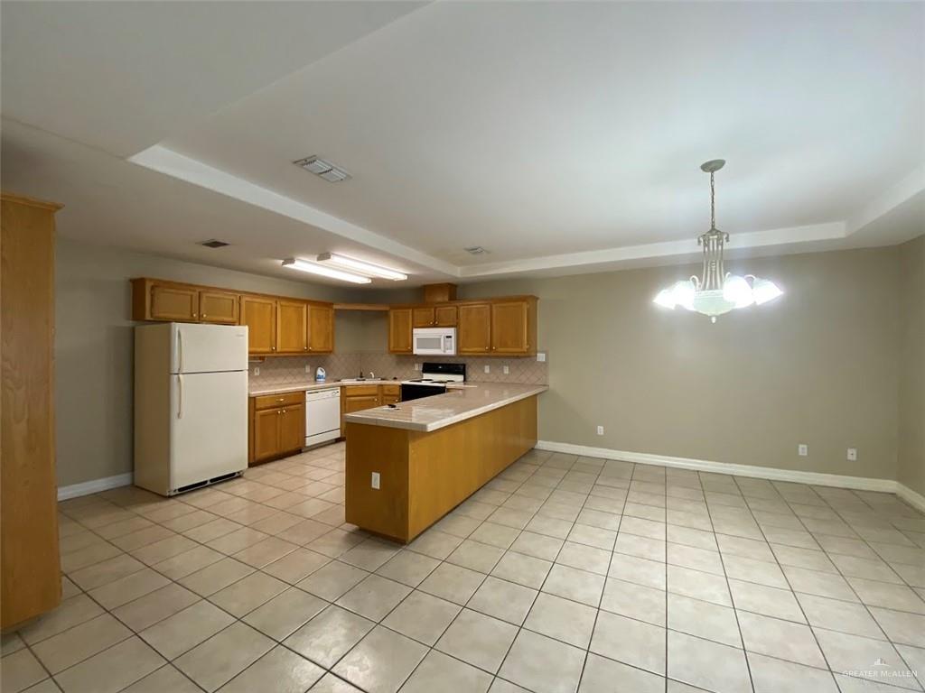 2409 North I Street, Unit G McAllen, TX 78501 - Photo 2 of 10 a large white kitchen with a sink and refrigerator