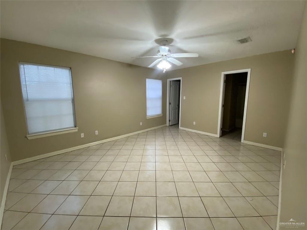 2409 North I Street, Unit G McAllen, TX 78501 - Photo 4 of 10 an empty room with windows and fan