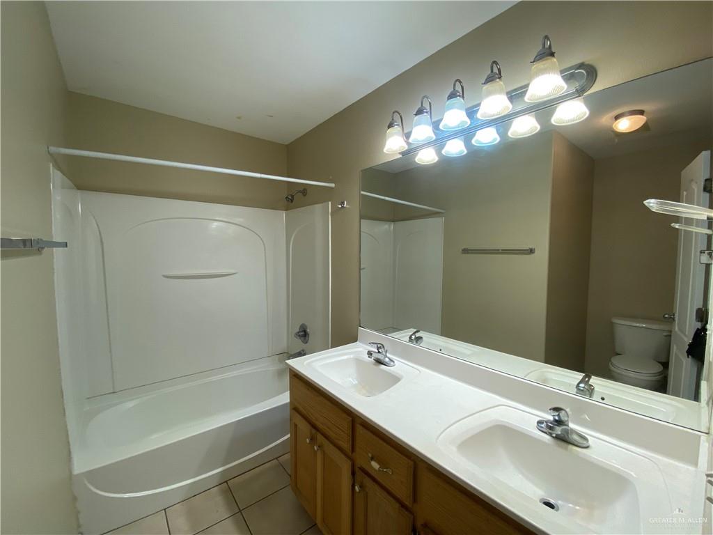 2409 North I Street, Unit G McAllen, TX 78501 - Photo 9 of 10 a bathroom with a sink double vanity and a mirror