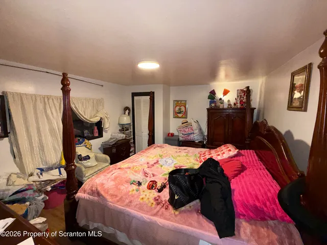 a bedroom with a bed and a dresser in it