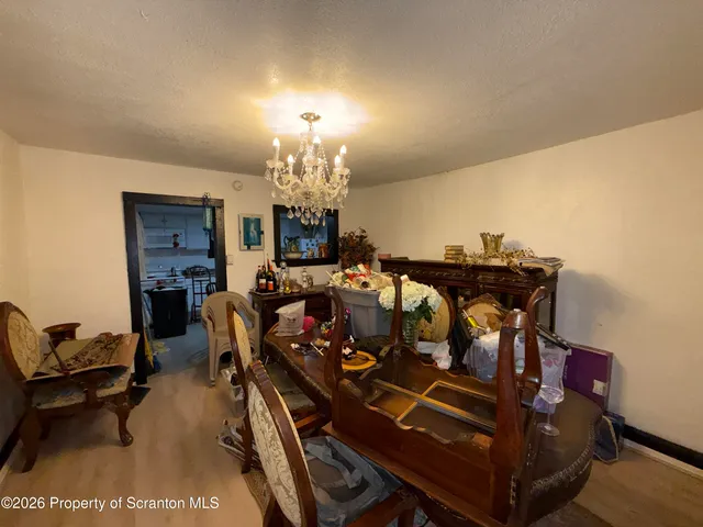 a view of a dining room with furniture and chandelier
